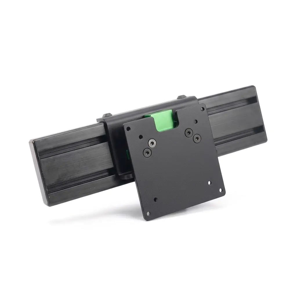 Black VESA monitor mounting plate attached to a section of black aluminum extrusion profile, viewed from the front on a white background.